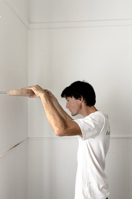 man installing Floating Shelving