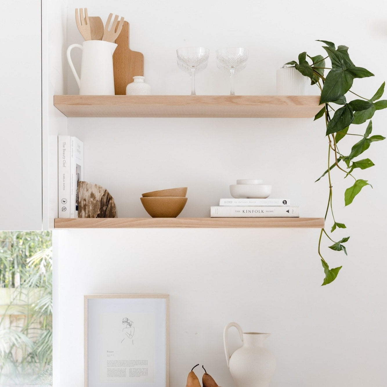 books and crockeries on timber floating shelves